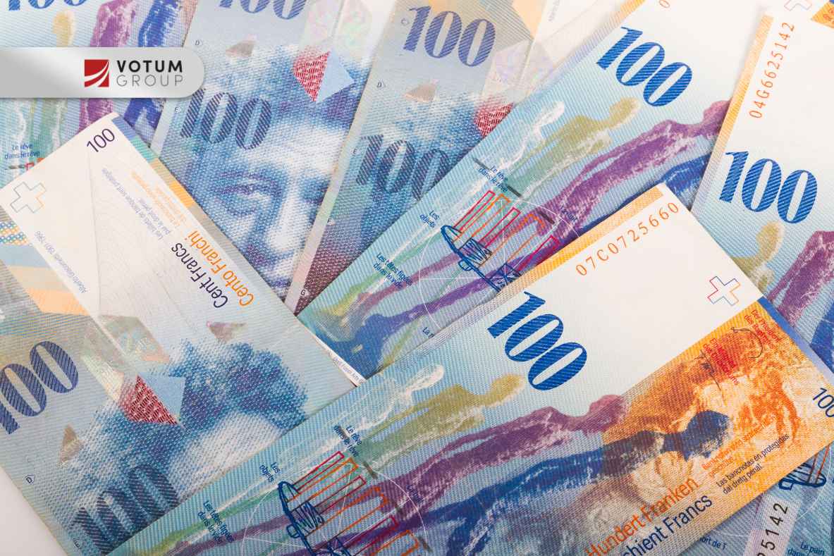 Banknoty 100 CHF (frank szwajcarski) przedstawione jako rozliczenia finansowe między bankiem a frankowiczem.